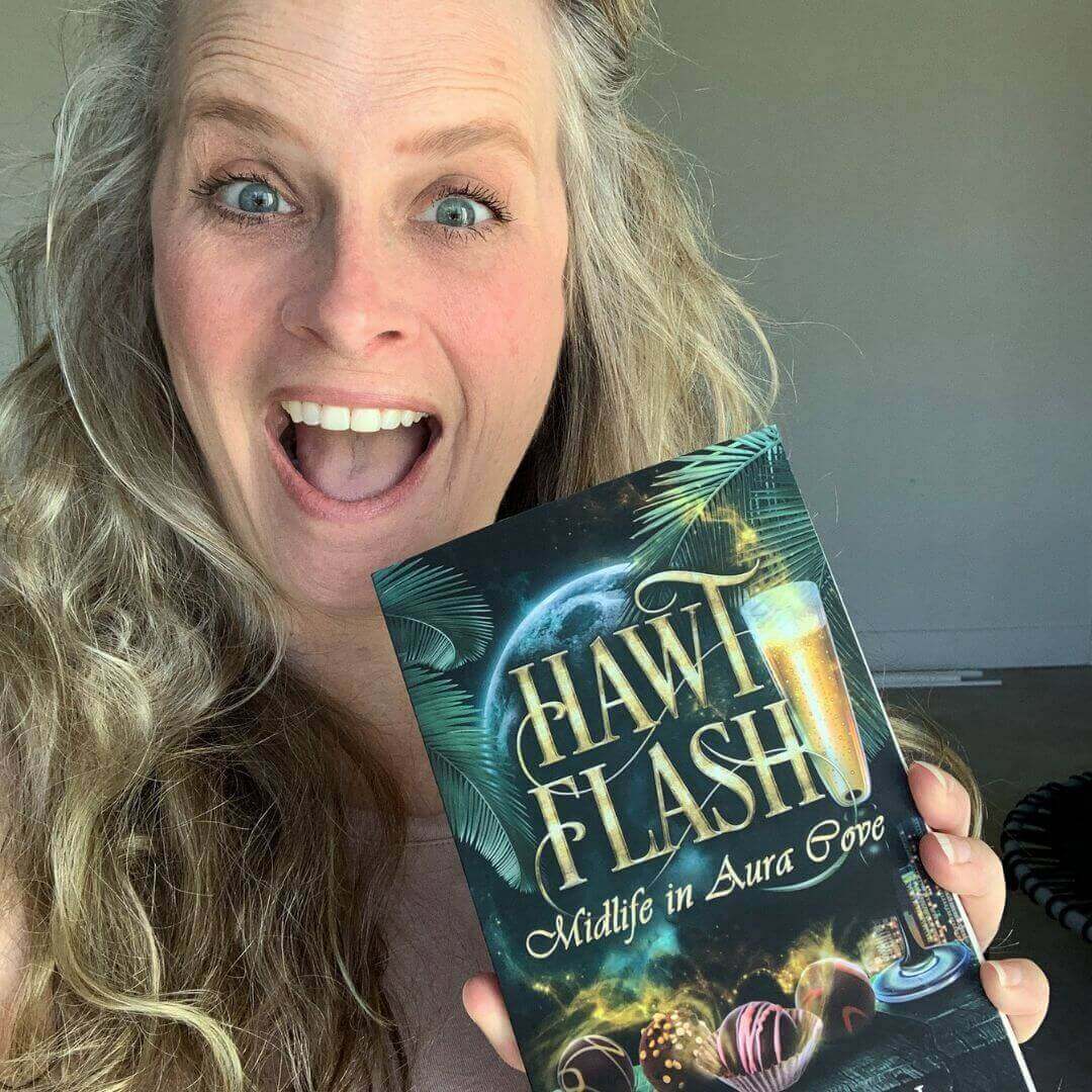 Woman excitedly holding 'Hawt Flash' audiobook, promoting women's fantasy fiction and paranormal stories.